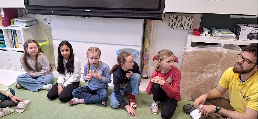 Pädagoge im Sitzkreis mit Kindern