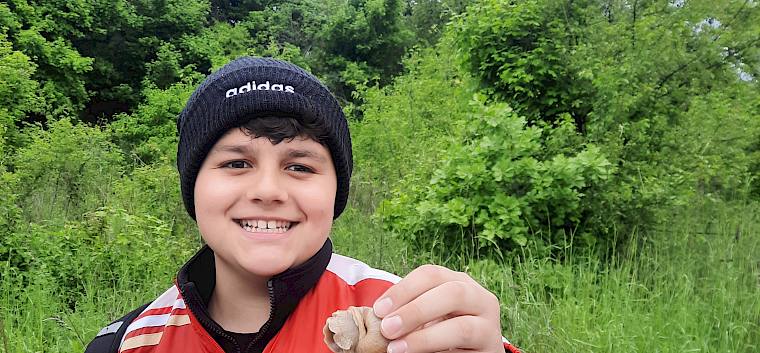 Bei dem feuchten Wetter, waren die ersten Weinbergschnecken schnell zu finden. © LPV/S. Leischner Jugendlicher mit Schnecke