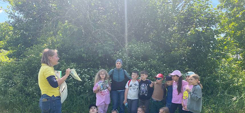 Frau zeigt Kindern Bild